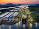 Vista aérea del Canal de Panamá con un buque atravesando una de sus esclusas al atardecer, una infraestructura clave para el comercio marítimo mundial.